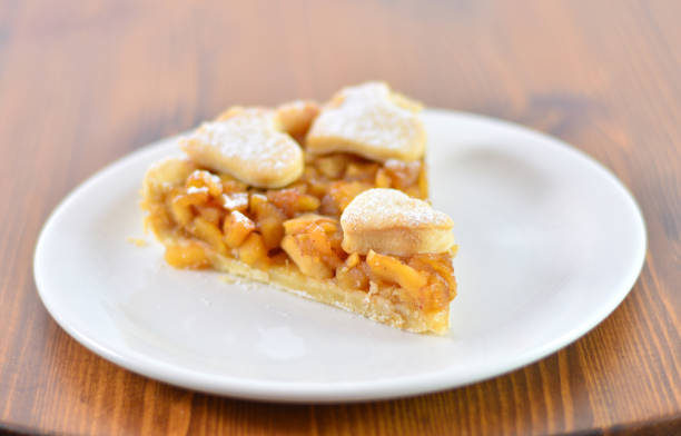 istock Fresh baked apple pie served with black plate on wooden table 922710466