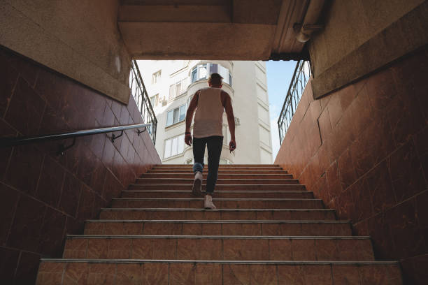 istock Young man climbing stairs in pedestrian subway 922711870
