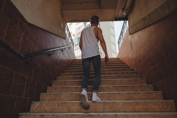 istock Young man climbing stairs in pedestrian subway 922711886