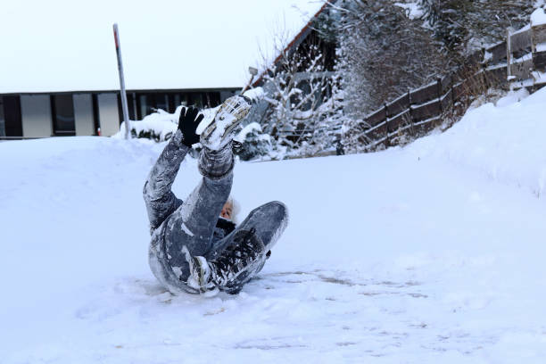 istock A woman falls on slippery road in winter 922712674