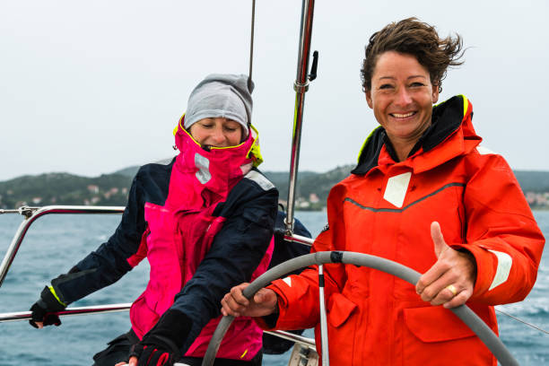 istock Cheerful Women Driving Sailing Boat 922714052