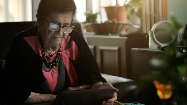 istock Senior youtuber elderly woman using tablet 922715666
