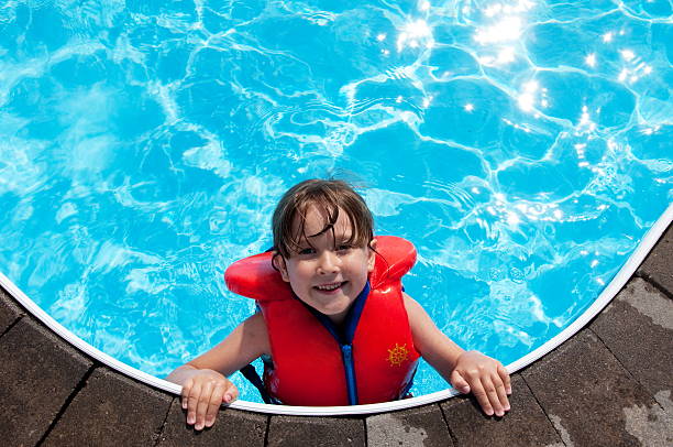 glückliche mädchen im pool - life jacket stock-fotos und bilder