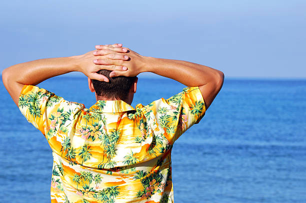 Man looking out to sea stock photo