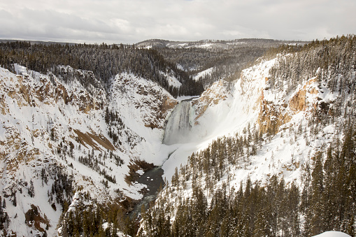 Landscape of Lower Falls from over Yellowstone River in Grand Canyon of Yellowstone National Park, Wyoming in winter.  Grand Canyon of Yellowstone National Park, Wyoming in winter.