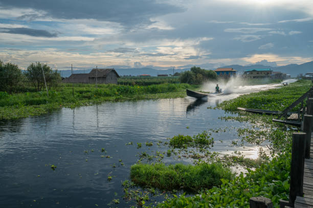 Beautiful sunset reflection on water lake surface at Inle lake or Nyaung Shwe in Myanmar