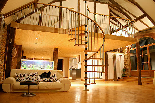 istock Large open living area with spiral staircase up to a loft 92272289