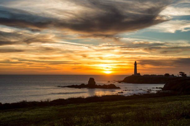 istock Pacific Coast Lighthouse Silhouetted Against Sunset Sky 922722892