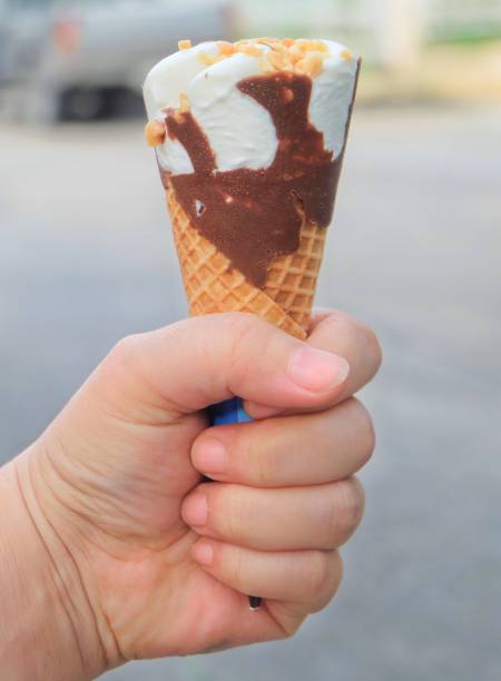 istock Hand Holding Ice Cream Cones with Chocolate 922726404