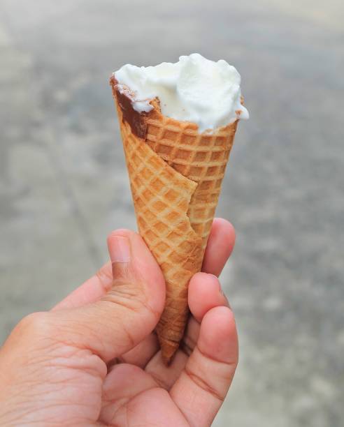istock Hand Holding Ice Cream Cones with Chocolate 922726414
