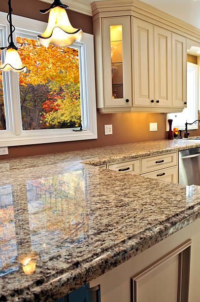 istock Granite countertop and white cabinets in modern kitchen 92272710