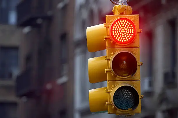 Photo of Traffic light on street with red signal lit up