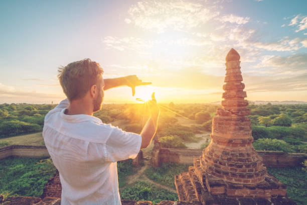 istock Caucasian young man framing the Bagan archeological zone at sunrise, Burma 922727728