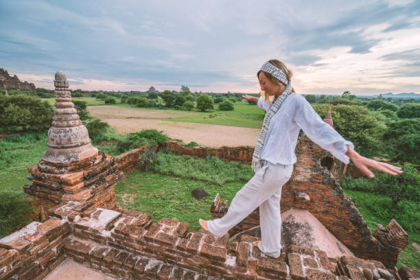 istock Woman balances on top of ancient temple, Bagan 922728030