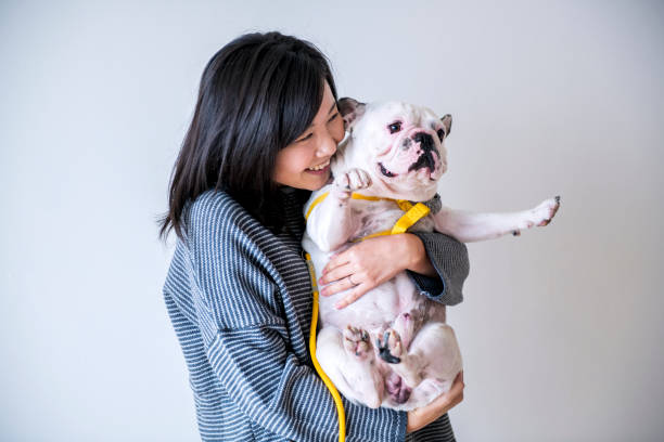 アジアの女性ハグ犬 - pets embracing one person portrait ストックフォトと画像