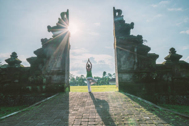 istock Female exercising yoga, Bali gate, Indonesia 922730254