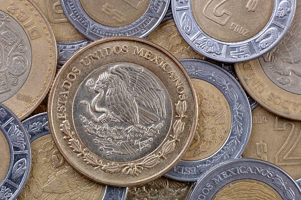 Close-up of various, shiny Mexican peso coins