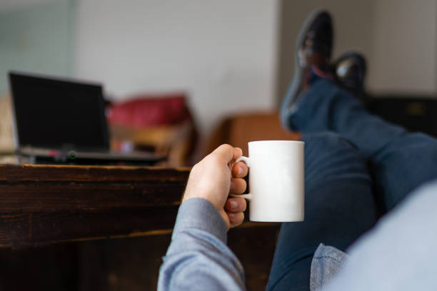 istock Business man relaxing with coffee at his desk 922731304