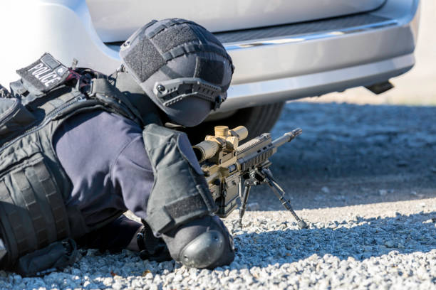 agente di polizia swat che spara con arma da fuoco - military uniform barricade boundary police uniform foto e immagini stock