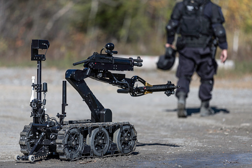 Police Swat Officer Using a Mechanical Arm Bomb Disposal Robot Unit