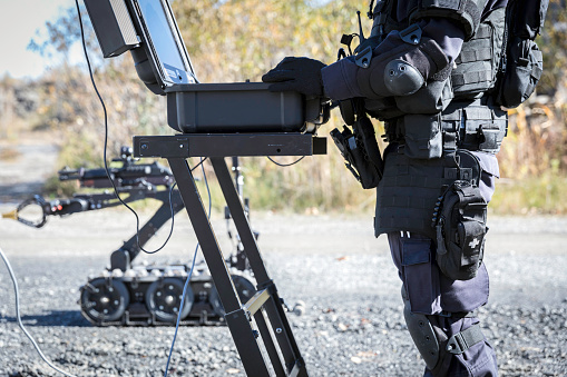 Police Swat Officer Using a Mechanical Arm Bomb Disposal Robot Unit