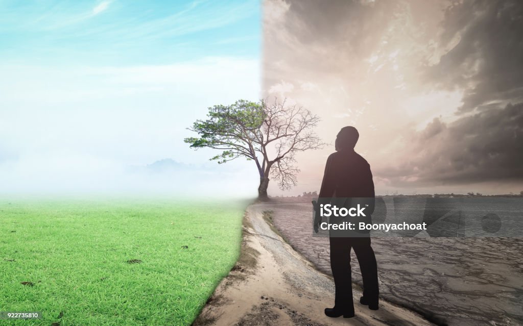 World change and global warming concept Business man standing between climate worsened with good atmosphere Globe - Navigational Equipment Stock Photo