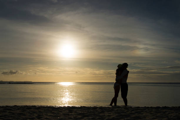 Sunset beach and couple of silhouette