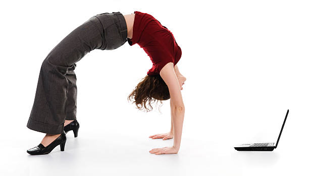 istock A businesswoman doing a backbend to look at a laptop screen 92273852