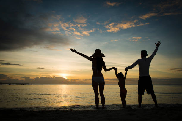 istock Family silhouette playing at the sunset beach 922738804