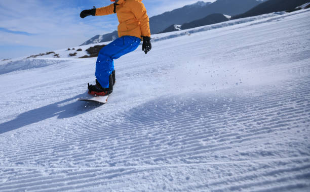 istock snowboarder snowboarding in winter mountains 922742336