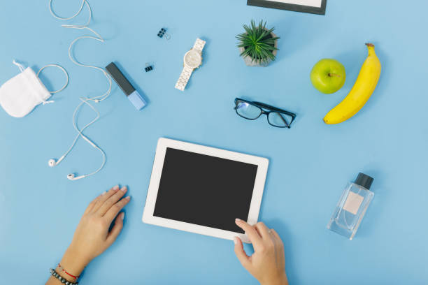 istock Female hands work with a tablet. Feminine Workplace concept. Flat lay, top view 922742356