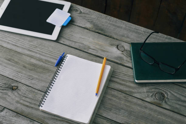 istock Notepad with pen on wooden office table. Home workspace concept 922742394