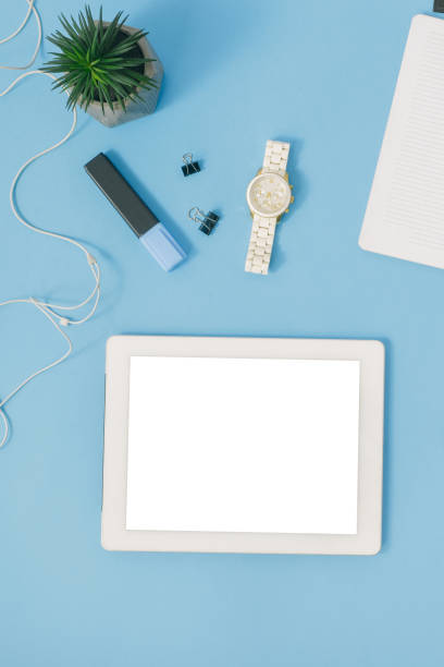 istock Home office workspace. Office table with white tablet blank screen on blue background. Flat lay 922742488