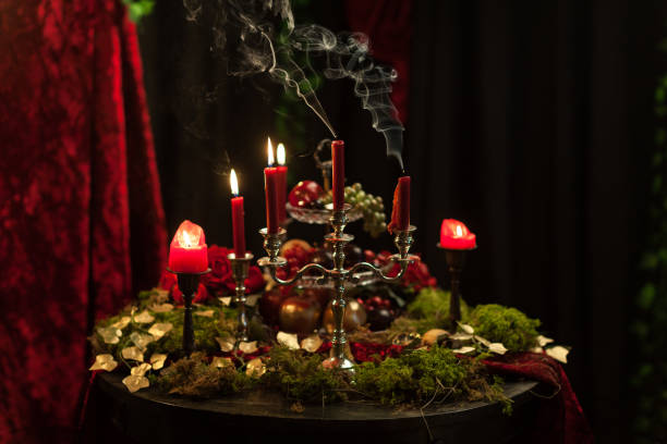 istock dark still life in red tones with candles, moss and roses 922743444