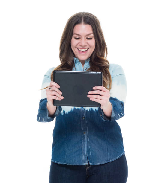 istock Cute female in blue outfit holding a tablet 922743924