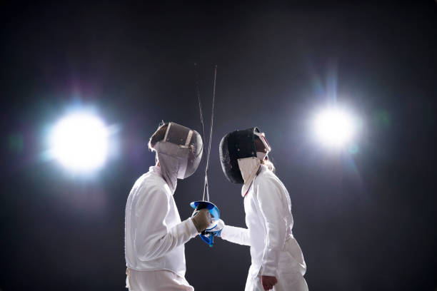 istock Fencers with foils standing face to face 922744928