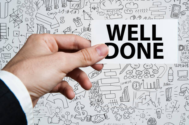 istock Businessman showing a card with text WELL DONE (Click for more) 922745784