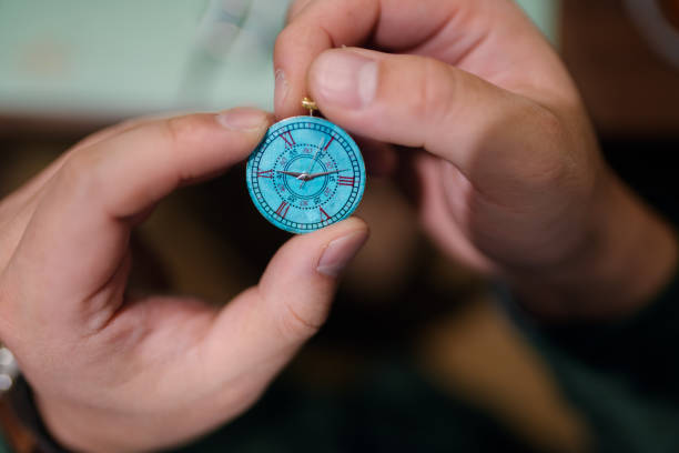 istock Close up of a watch maker adjust the hands on a clock face 922745902