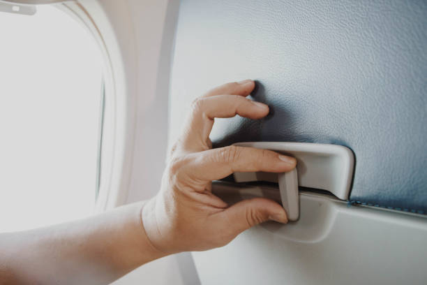 istock woman hand open tray at the seat back 922746624