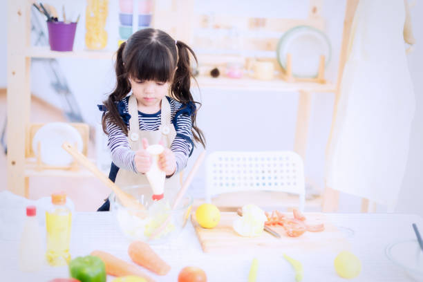 istock Little girl chef preparing vegetable soup. 922750464