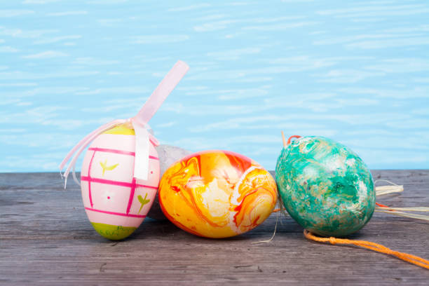 Two red easter eggs among deisies
