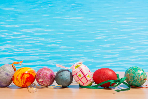 Easter in pool, wellness and relax. Eggs and water background for party and spa Easter in pool, wellness and relax. Eggs and water background for party and spa spring swim stock pictures, royalty-free photos & images