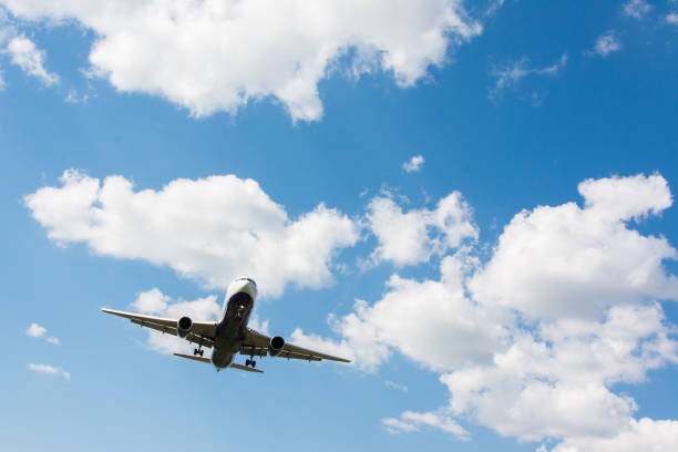 istock Airplane landing. Clouds and blue sky background, with copy space 922752560