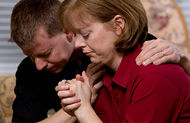 Couple praying together stock photo