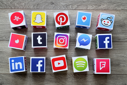 İstanbul, Turkey - February 14, 2018: Paper cubes with popular social media services icons, including Facebook, Instagram, Youtube, Twitter on a wooden desk.