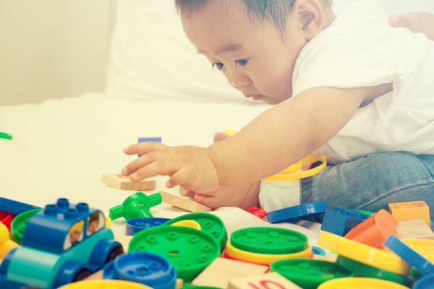 istock little baby playing with colorful plastic blocks 922754664