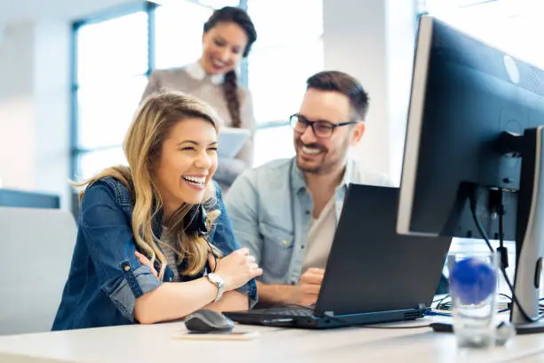 Photo of Group of business people and software developers working as a team in office