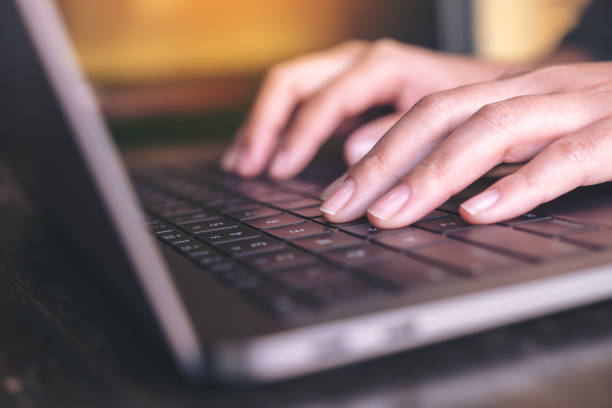 istock Closeup image of hands working and typing on laptop keyboard on the table 922761714