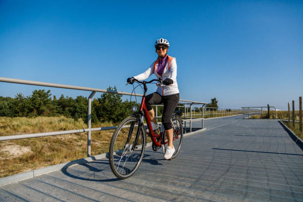 istock Woman riding bike at seaside 922764272