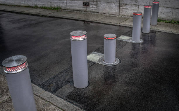 Retractable (lifting) bollards Retractable (lifting) bollards with warning light to enable or block traffic retractable photos stock pictures, royalty-free photos & images